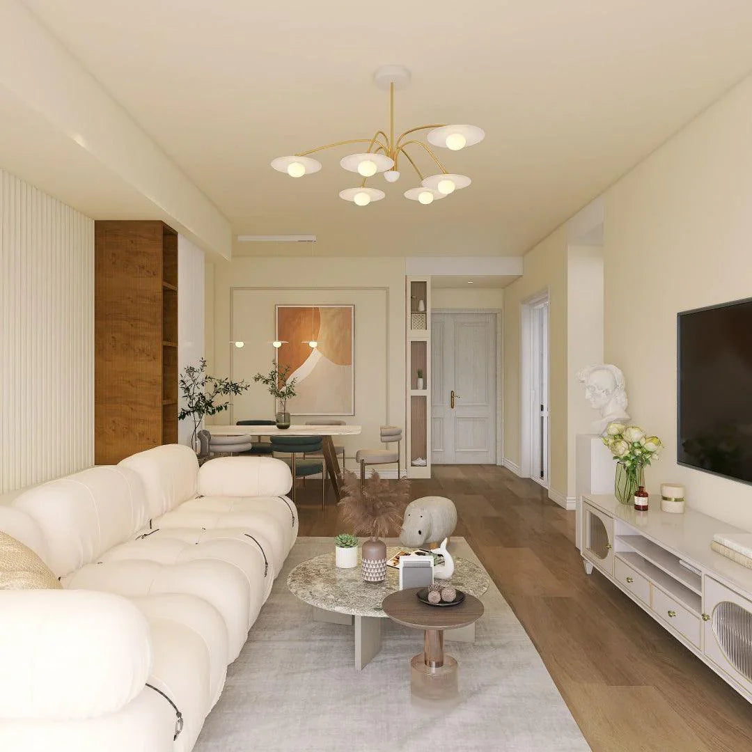 Modern living room with white plush sofa, round marble coffee table, and gold 6-head pendant chandelier