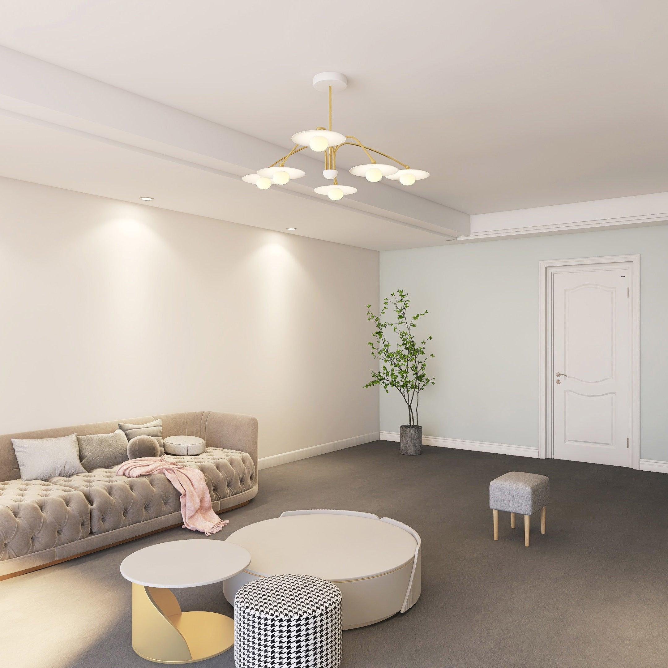 Modern living room with a gold and white 6-head champignon chandelier from YH Lamps above beige tufted sofa and round coffee tables