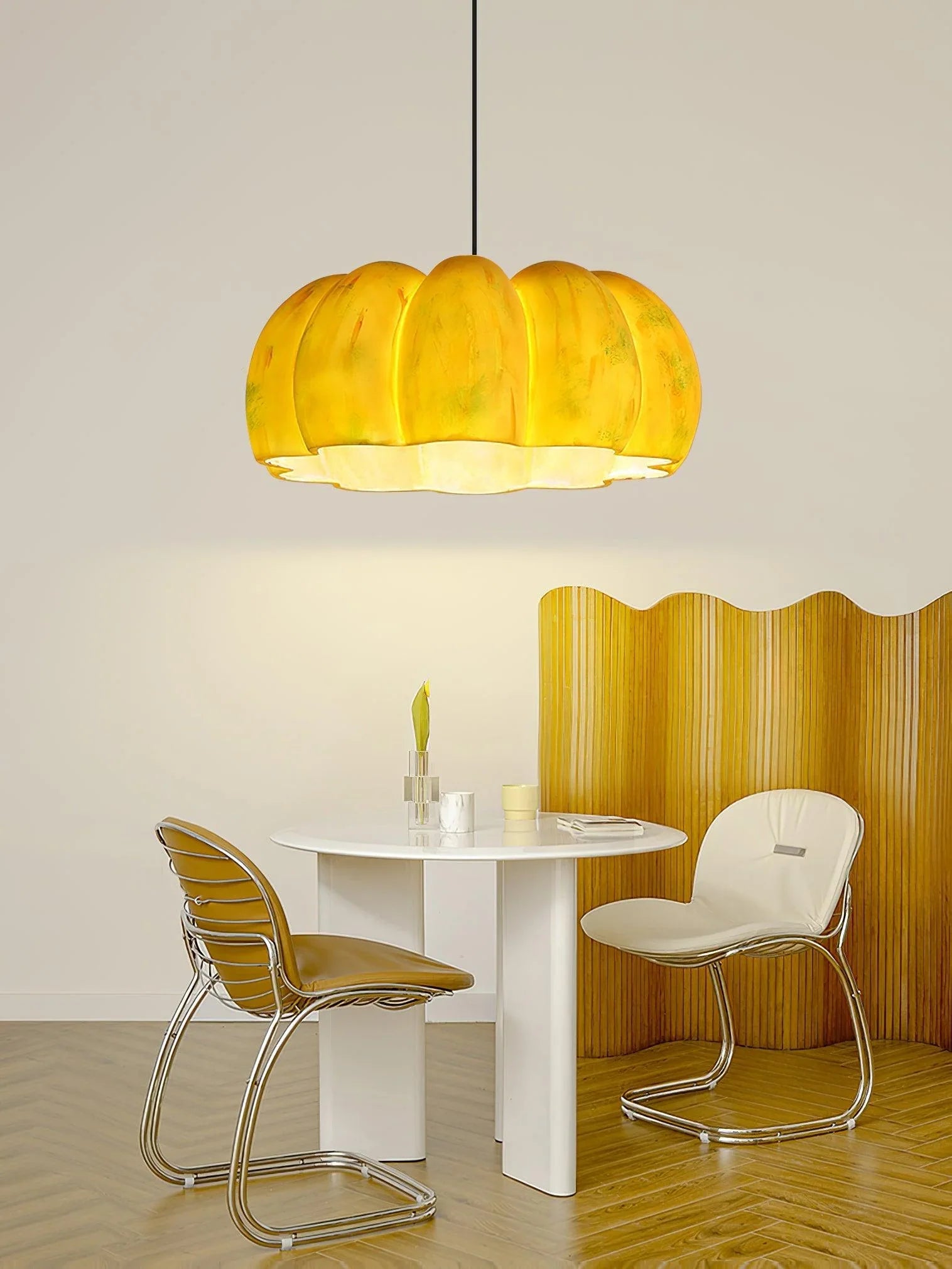 Modern dining room with yellow pumpkin-shaped pendant lamp, white table, and two chairs