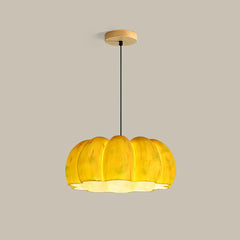 Modern yellow pumpkin-shaped pendant lamp chandelier by YH Lamps, hanging on beige wall