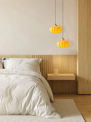 Yellow pumpkin pendant lights above modern wood nightstand in cozy bedroom, YH Lamps style