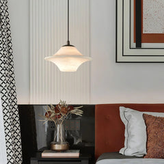 Modern alabaster pendant lamp with black fixture over bedside table in stylish bedroom