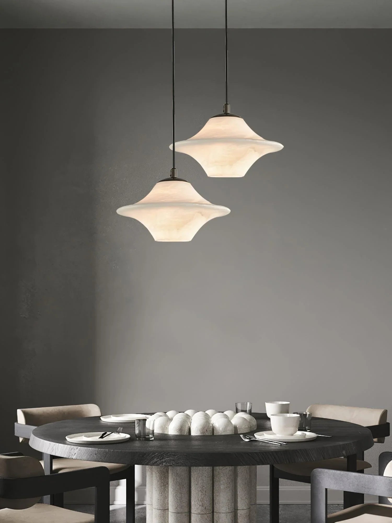 Modern dining room with black round table, beige chairs, and two alabaster pendant lamps by YH Lamps