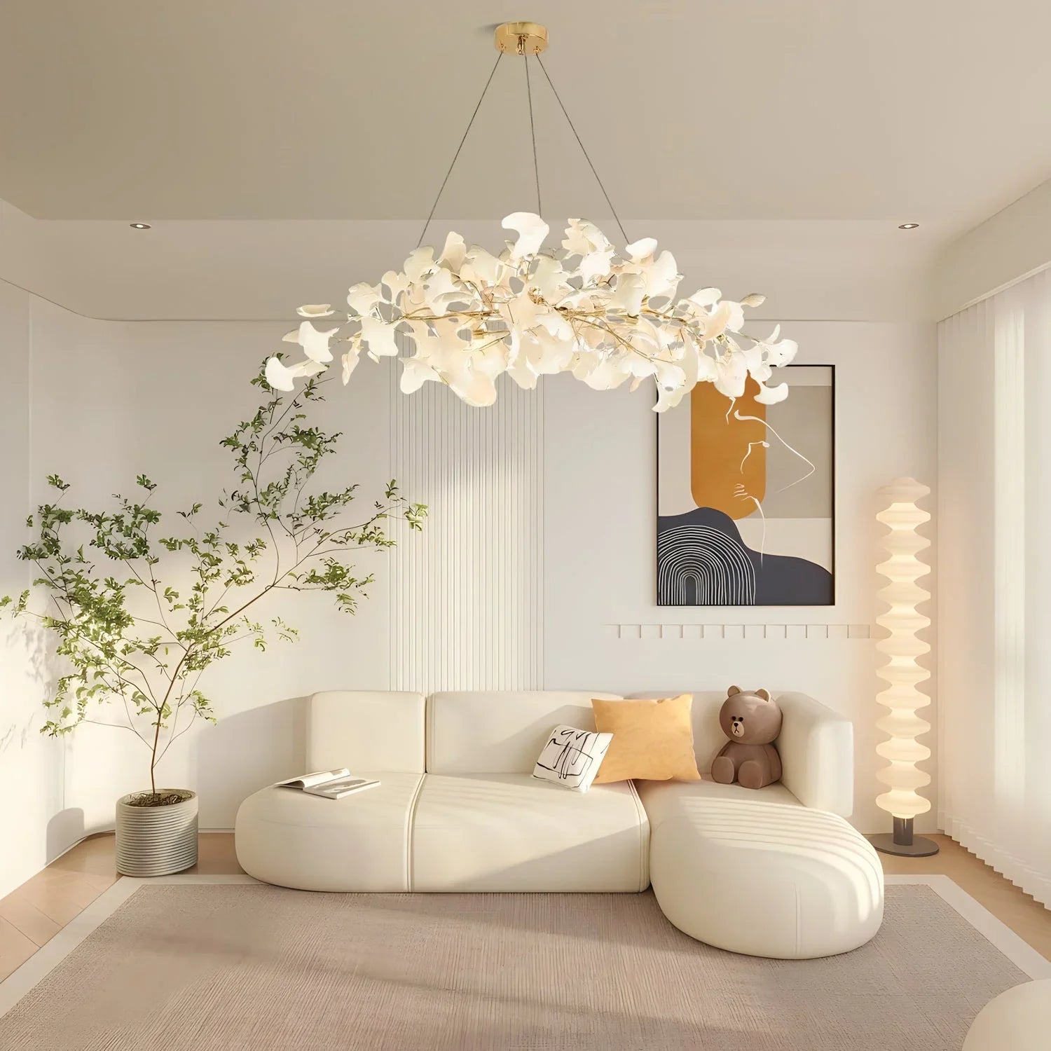 Modern living room with white ginkgo chandelier pendant lamp, beige sectional sofa, floor lamp, and abstract wall art