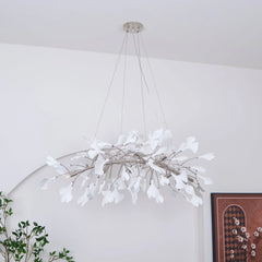Modern white gingko leaf chandelier pendant lamp with gold accents in minimalist room