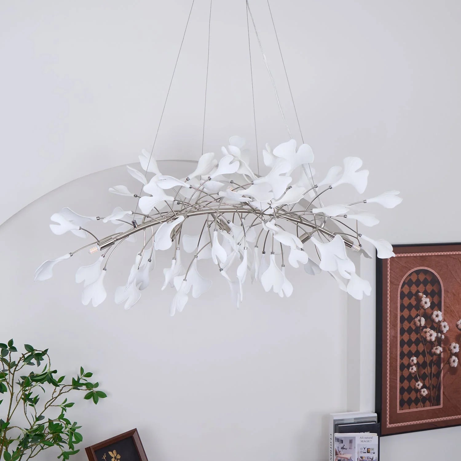 Modern white gingko leaf chandelier pendant lamp with gold stems hanging in stylish room