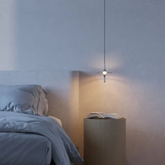 Modern crystal pendant lamp by YH Lamps above nightstand in minimalist bedroom