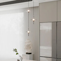 Modern crystal pendant chandelier with three hanging lights in a minimalist dining room