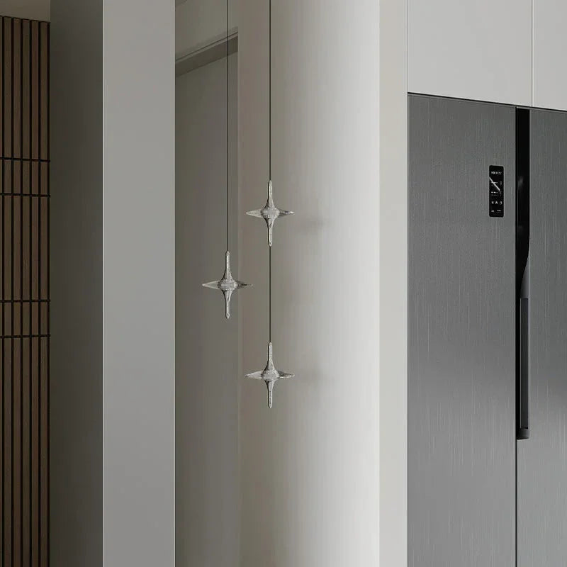 Modern crystal pendant lamps by YH Lamps hanging in a minimalist kitchen interior