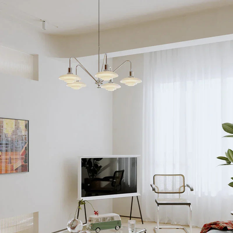 Modern silver pendant chandelier by YH Lamps illuminating a stylish living room.