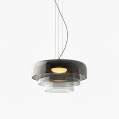 Modern smoke grey layered glass pendant chandelier with warm light, suspended by cables