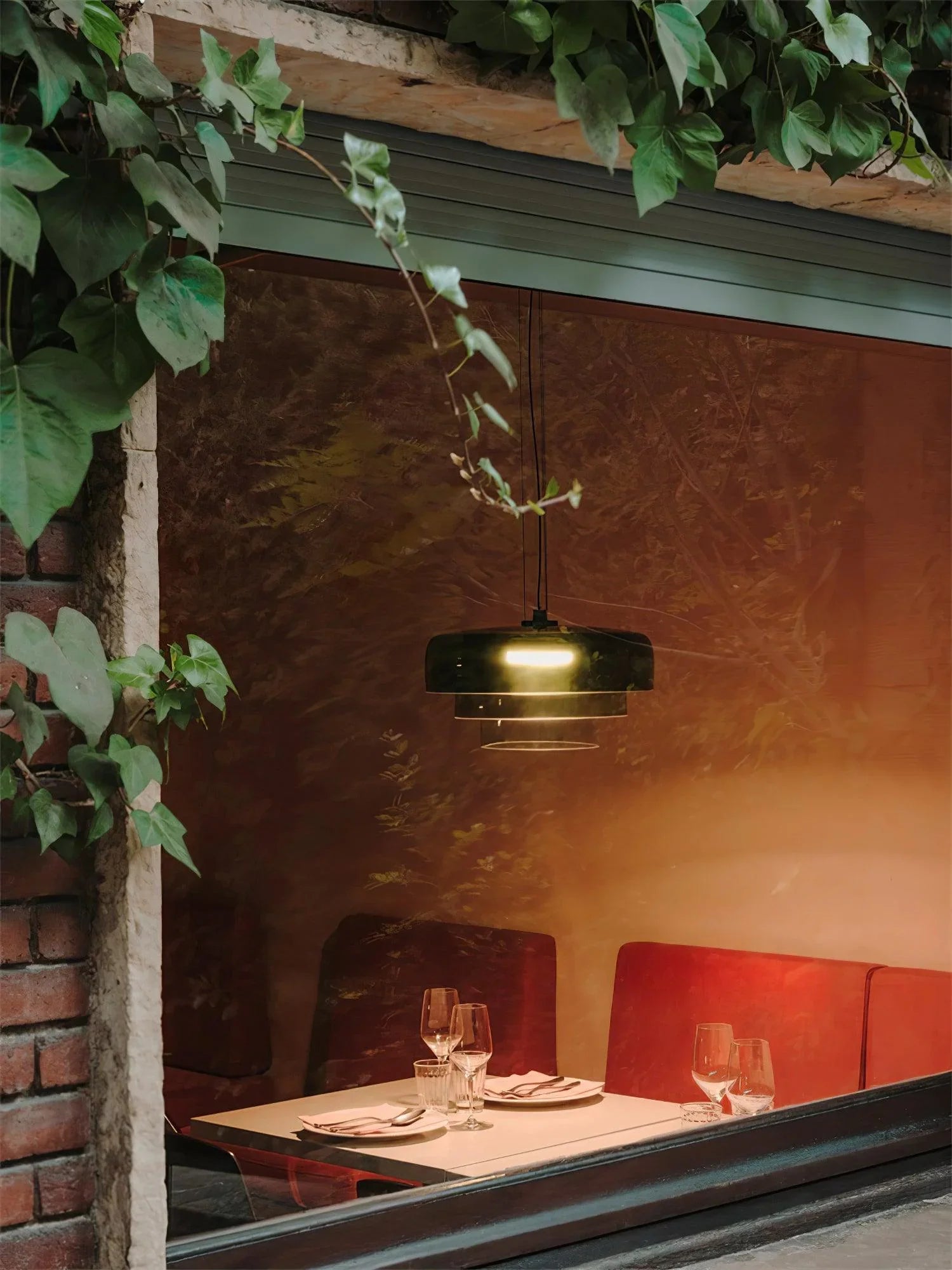 YH Lamps modern smoke grey pendant lamp over cozy restaurant table with red seating and glassware