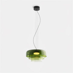 Modern green glass pendant chandelier with layered circular design and warm light, suspended by thin cables