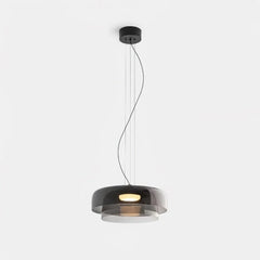 Modern smoke grey pendant lamp with warm light, suspended by thin wires on white background