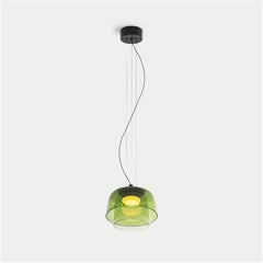 Modern green glass pendant lamp with warm light, suspended by black cords from black ceiling mount