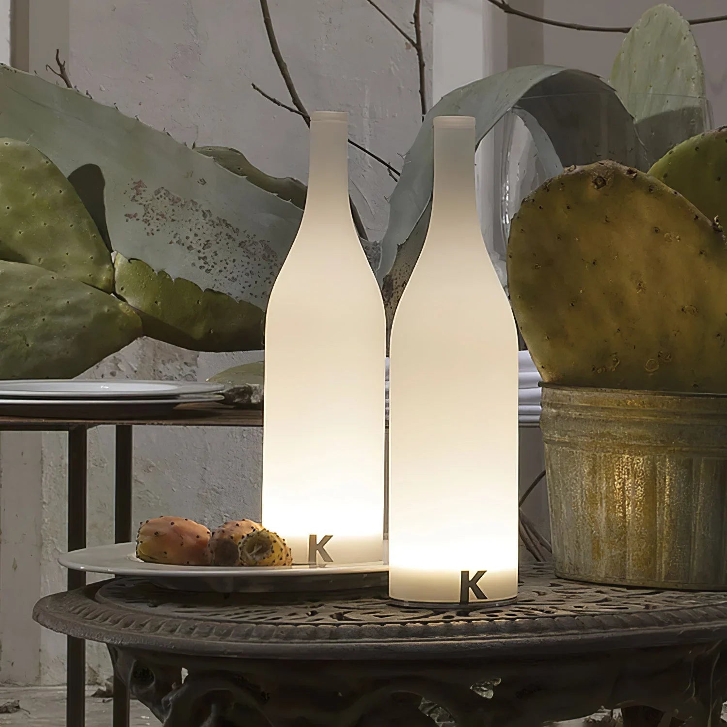 Modern white bottle-shaped table lamps with warm light on decorative outdoor table, YH Lamps