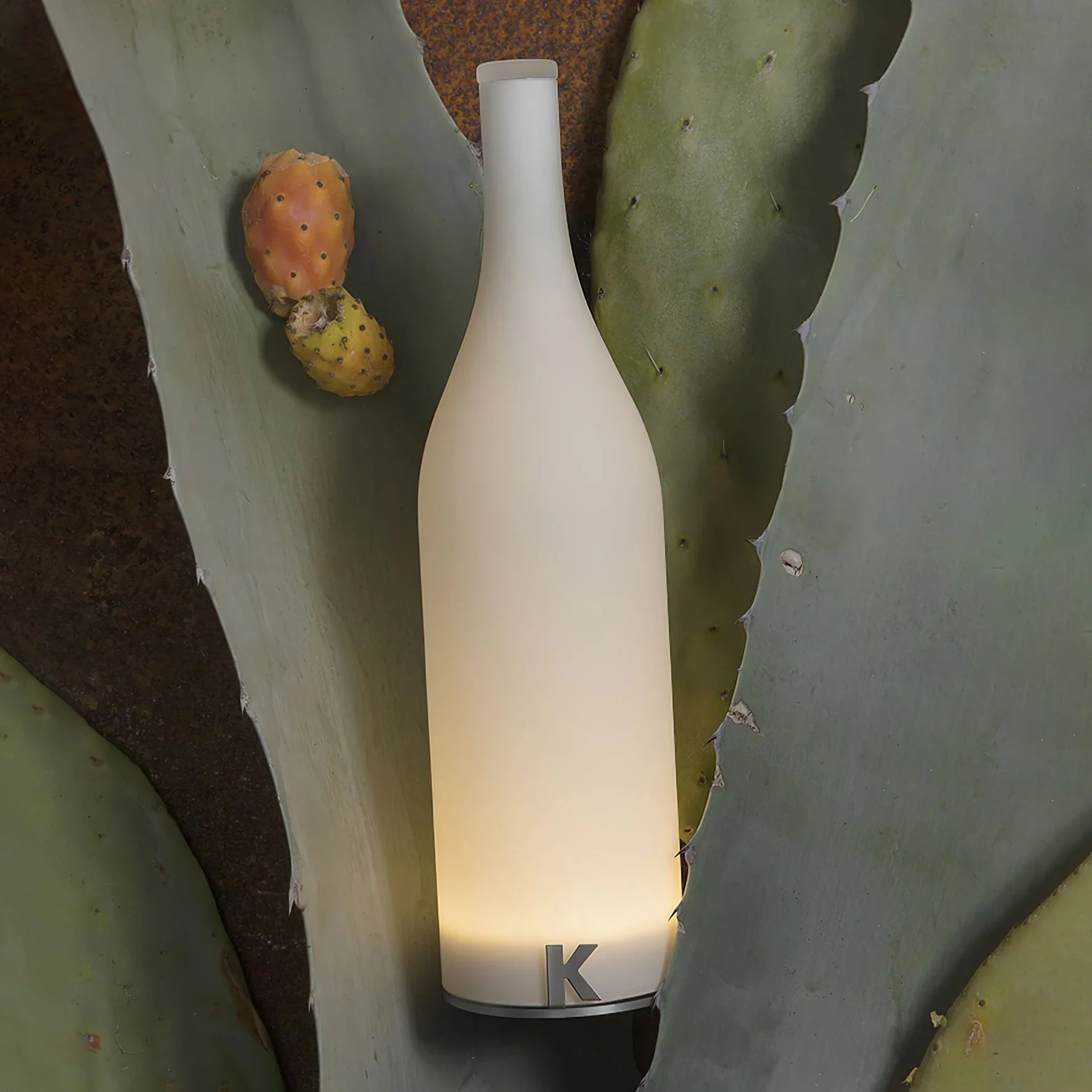 Modern white bottle-shaped table lamp with warm light on cactus leaves, YH Lamps design
