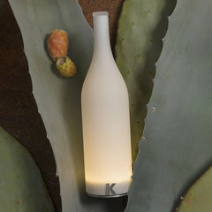 Modern white bottle-shaped table lamp with warm light on cactus leaves, YH Lamps design