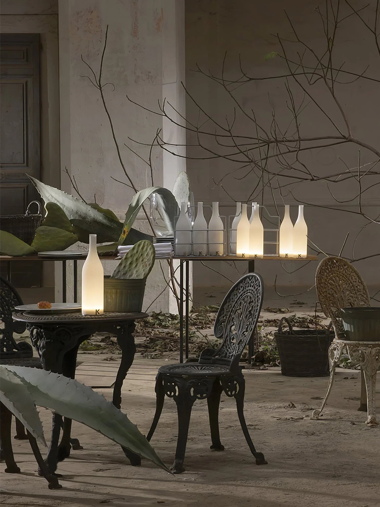 Modern bottle-shaped table lamps with warm white light on rustic patio, YH Lamps decor