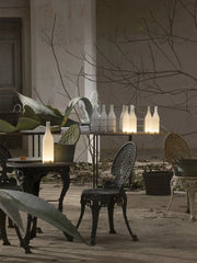 Modern bottle-shaped table lamps with warm white light on rustic patio, YH Lamps decor