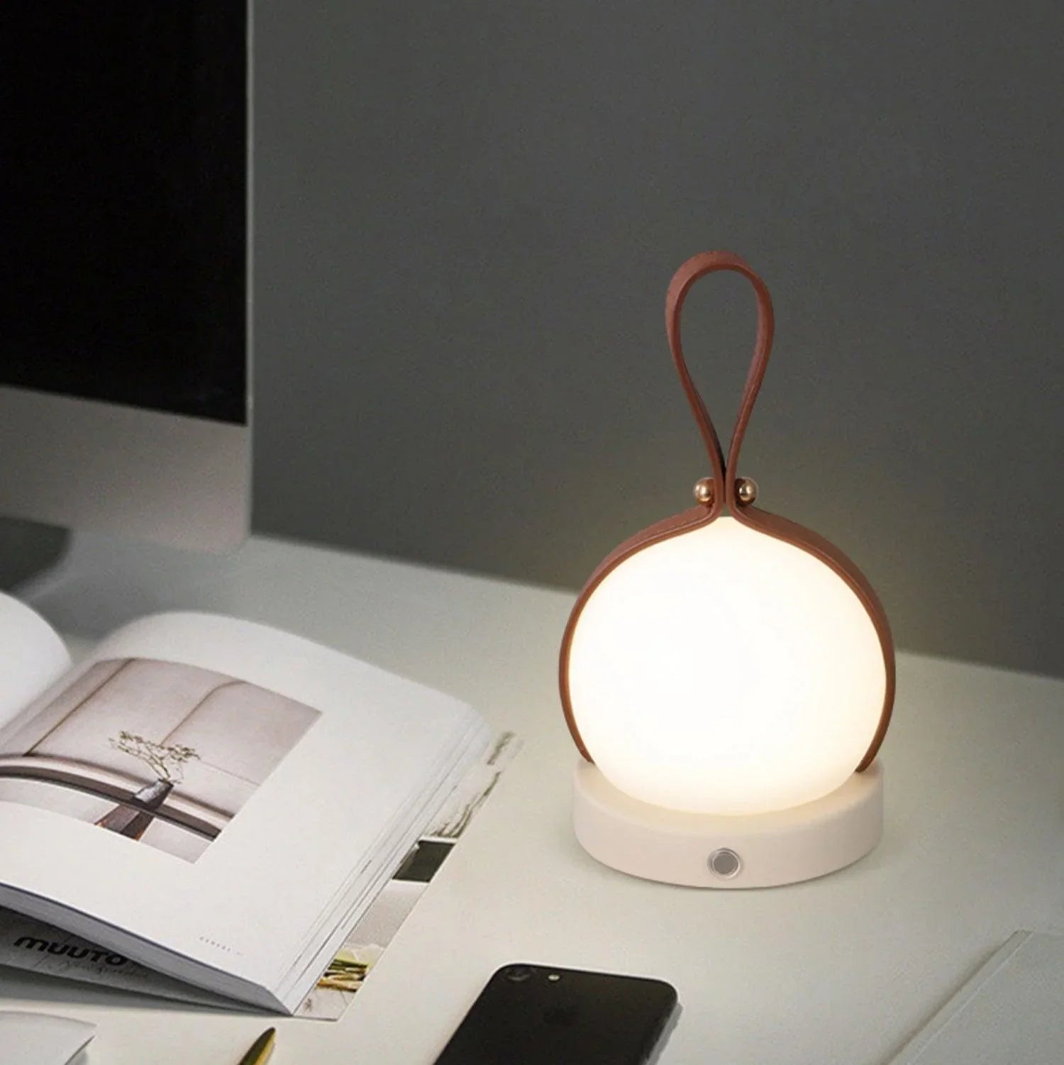 Modern YH Lamps bola lantern LED table lamp with brown handle on a desk, touch switch visible