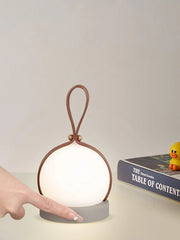 Modern YH Lamps portable table lamp with brown loop handle and touch switch on bedside table