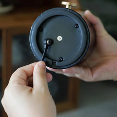 Close-up of hands plugging USB cable into YH Lamps black table lamp with built-in battery
