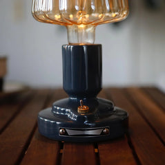 Modern black USB table lamp with amber glass shade on wooden surface, YH Lamps lighting