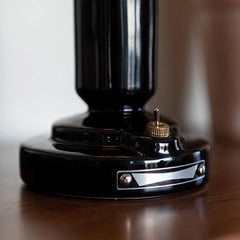 Close-up of modern black table lamp base with brass switch, YH Lamps home lighting