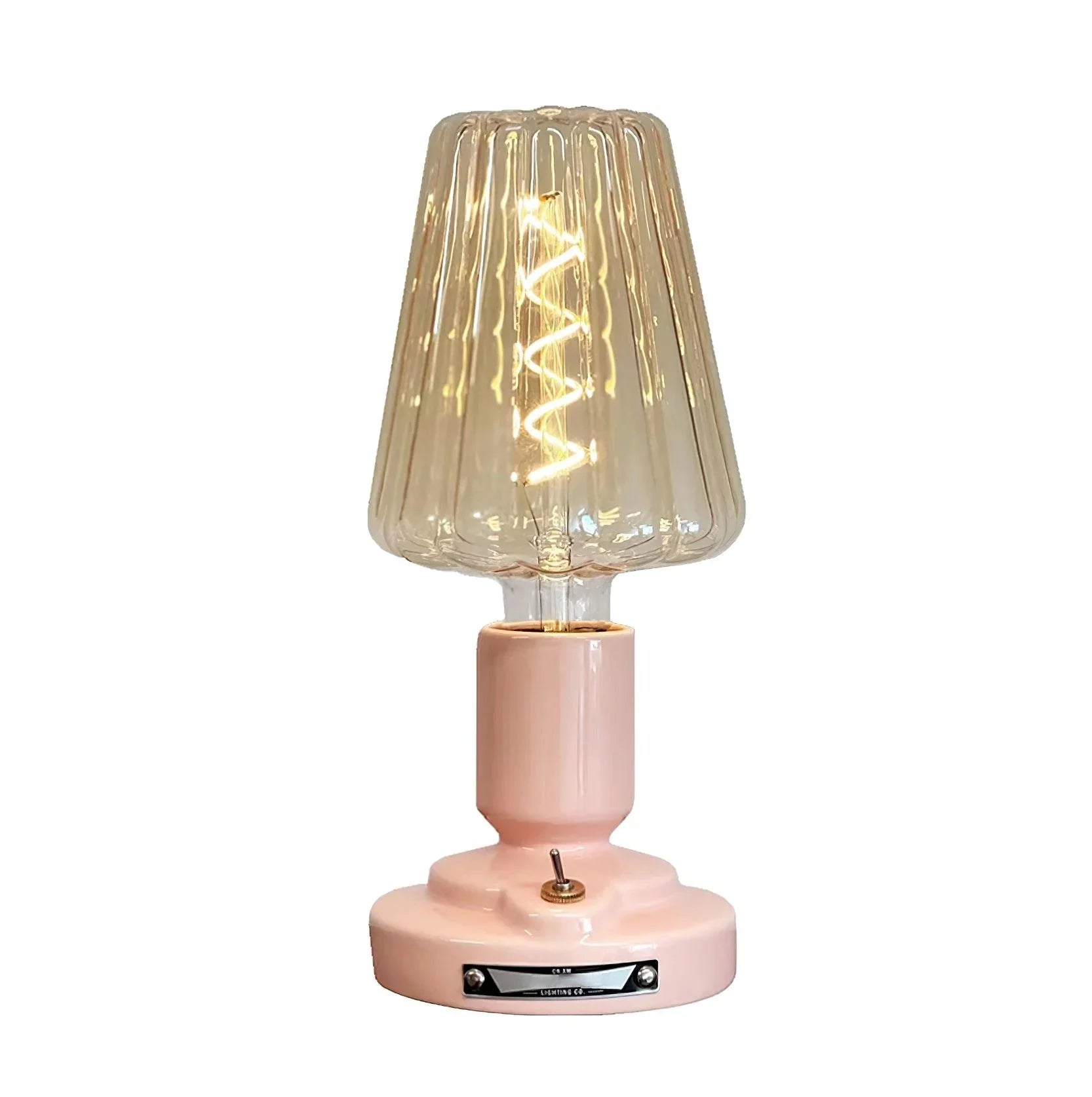 Modern pink table lamp with ribbed glass shade and spiral LED bulb from YH Lamps.
