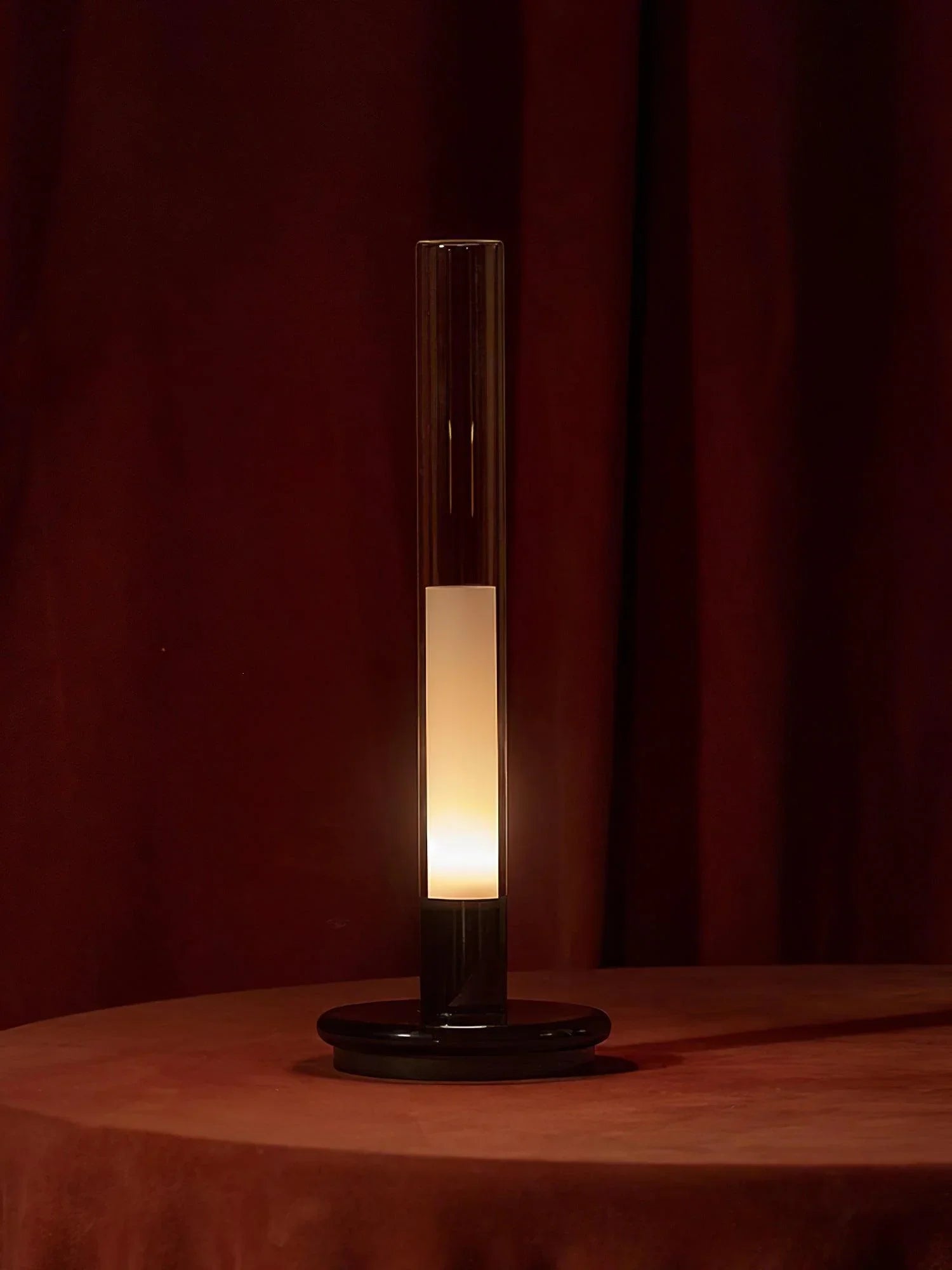 Modern black and clear column table lamp with warm light on a round table, YH Lamps