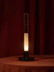 Modern black and clear column table lamp with warm light on a round table, YH Lamps