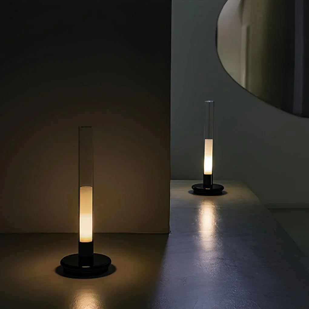 Modern YH Lamps black and clear column table lamp with warm light on a minimalist surface