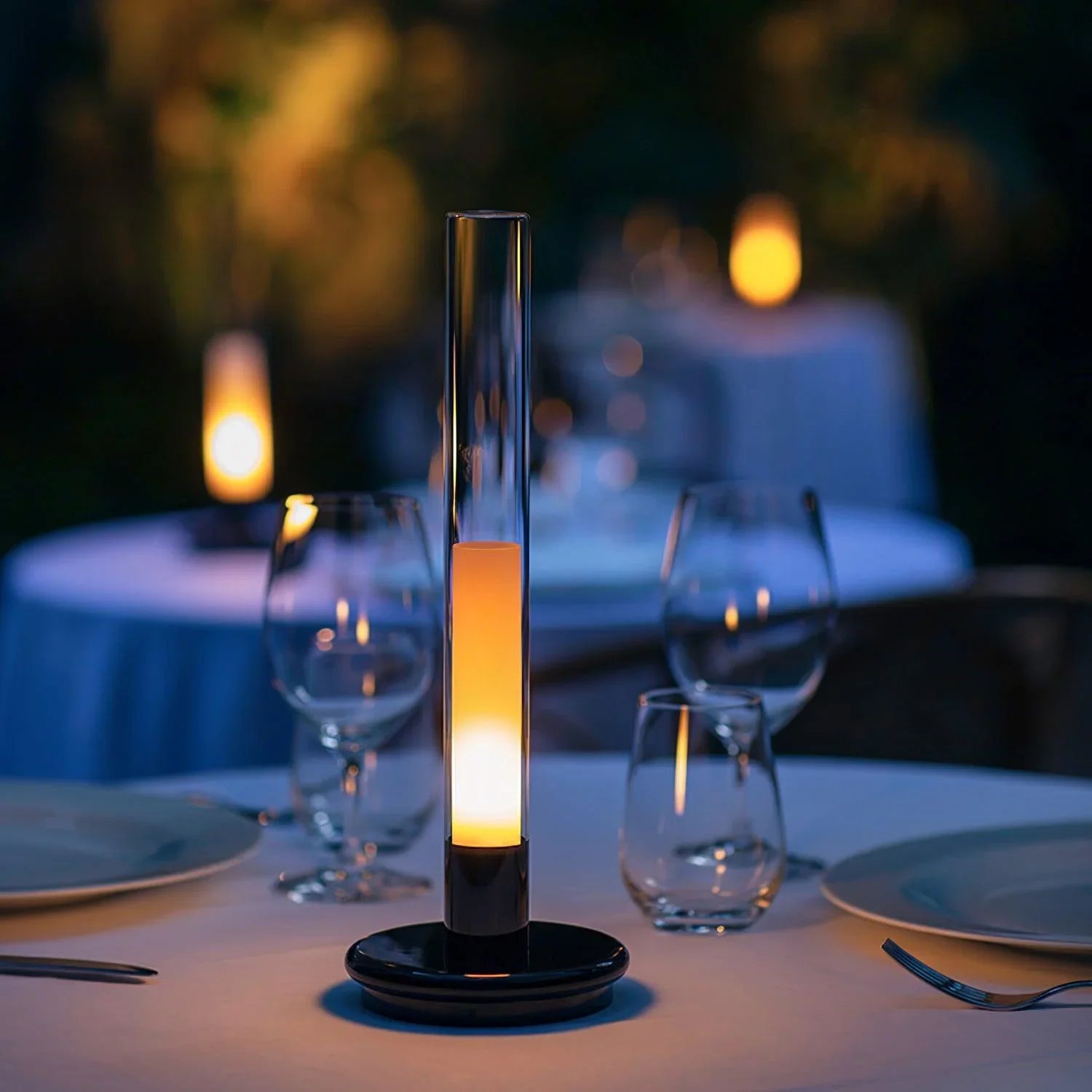 Modern black and clear column table lamp with warm LED light on elegant dining table, YH Lamps