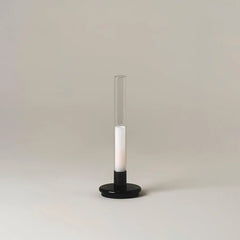 Modern black and clear column table lamp with warm light on neutral background, YH Lamps