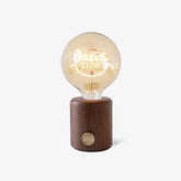 Modern walnut table lamp with round glass bulb and glowing filament, YH Lamps product