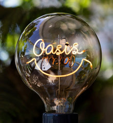 Walnut USB table lamp with transparent glass bulb and smiley face filament by YH Lamps