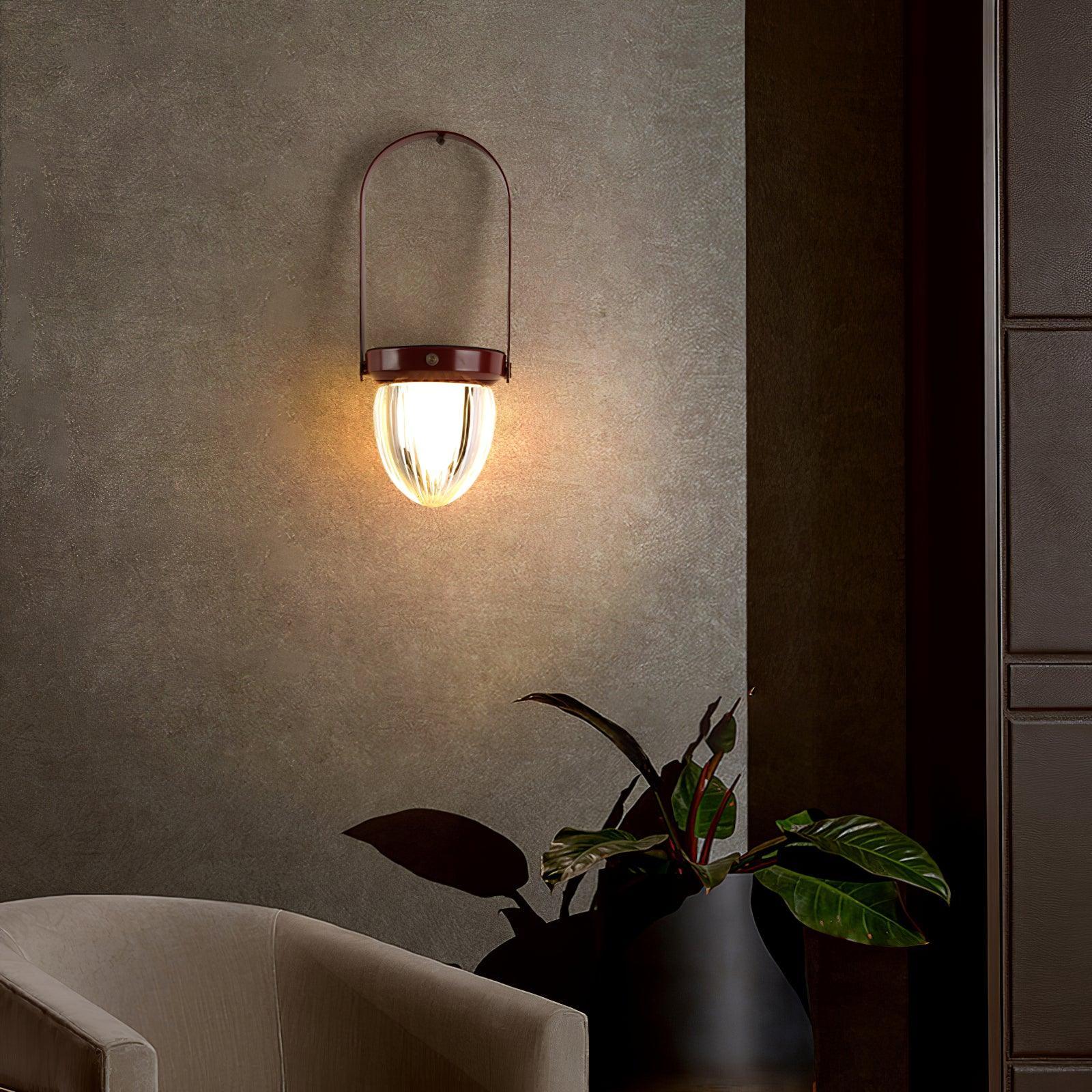 Modern wall sconce with glass shade by YH Lamps, illuminating a stylish living room corner.