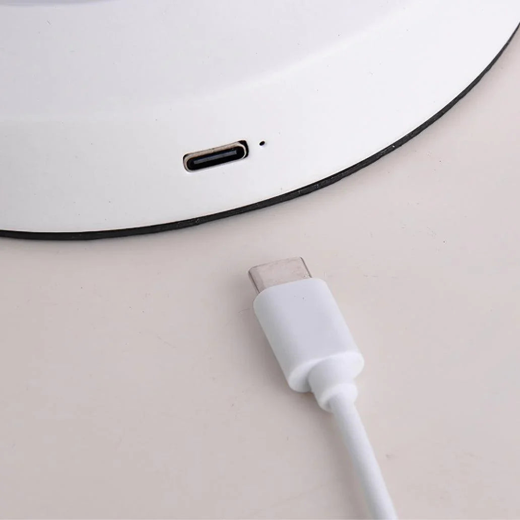 Close-up of a white table lamp base with USB-C charging port and matching cable from YH Lamps