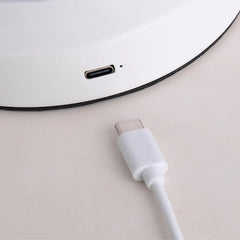 Close-up of a white table lamp base with USB-C charging port and matching cable from YH Lamps