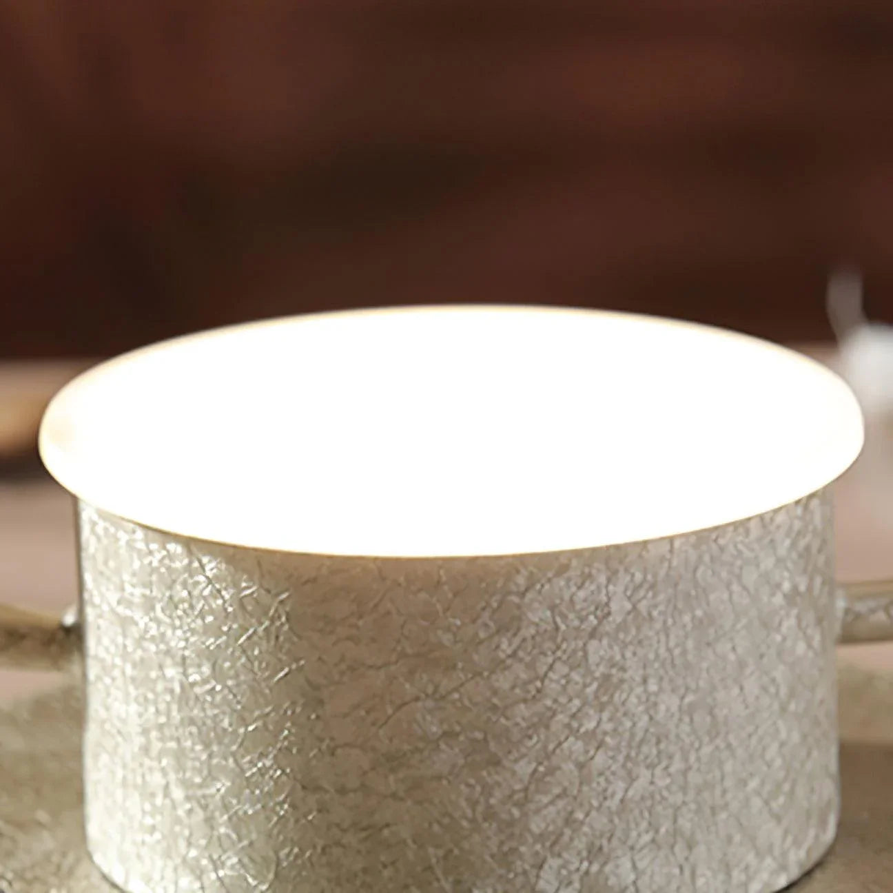 Modern dark gray cylindrical table lamp with textured finish by YH Lamps, softly glowing light