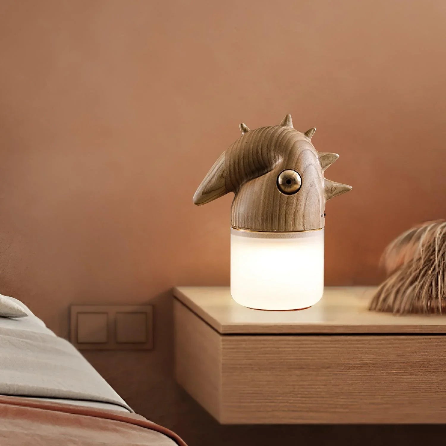 Modern wood color table lamp with dinosaur-shaped design and warm light on bedside table, YH Lamps