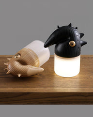 Modern wooden table lamps with animal-inspired designs from YH Lamps, displayed on wood surface