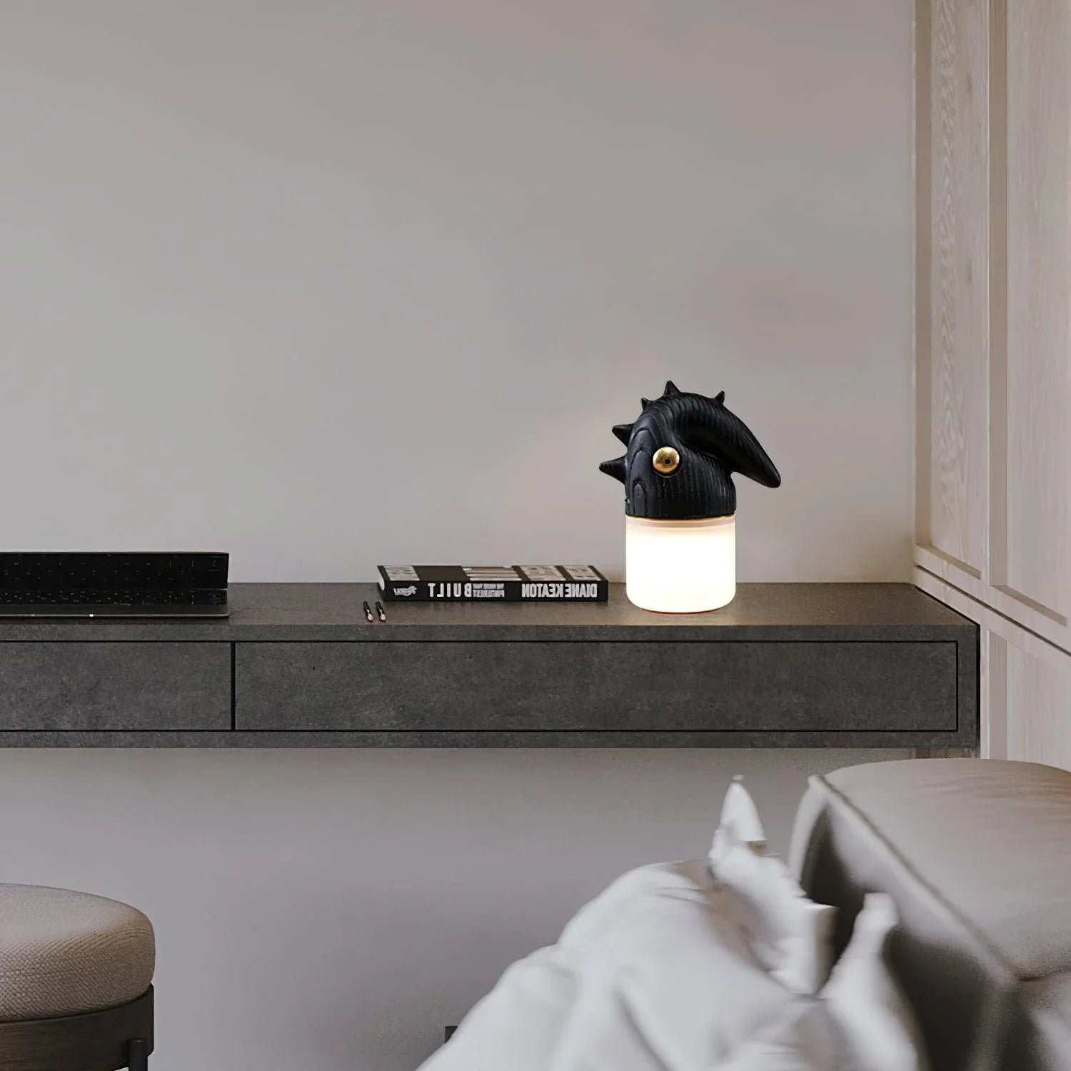 Modern black and white table lamp with sculptural top on a minimalist desk, YH Lamps.