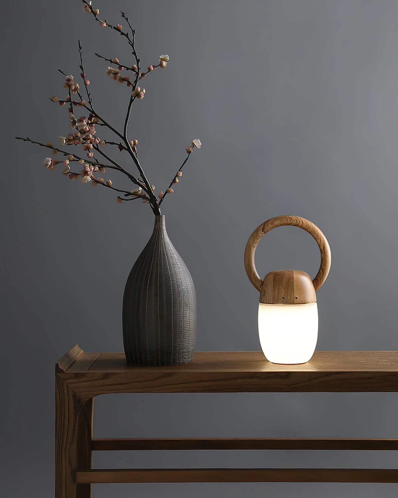 Modern wooden Zen table lamp with warm light beside a vase on a minimalist wood table, YH Lamps