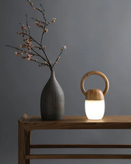 Modern wooden Zen table lamp with warm light beside a vase on a minimalist wood table, YH Lamps