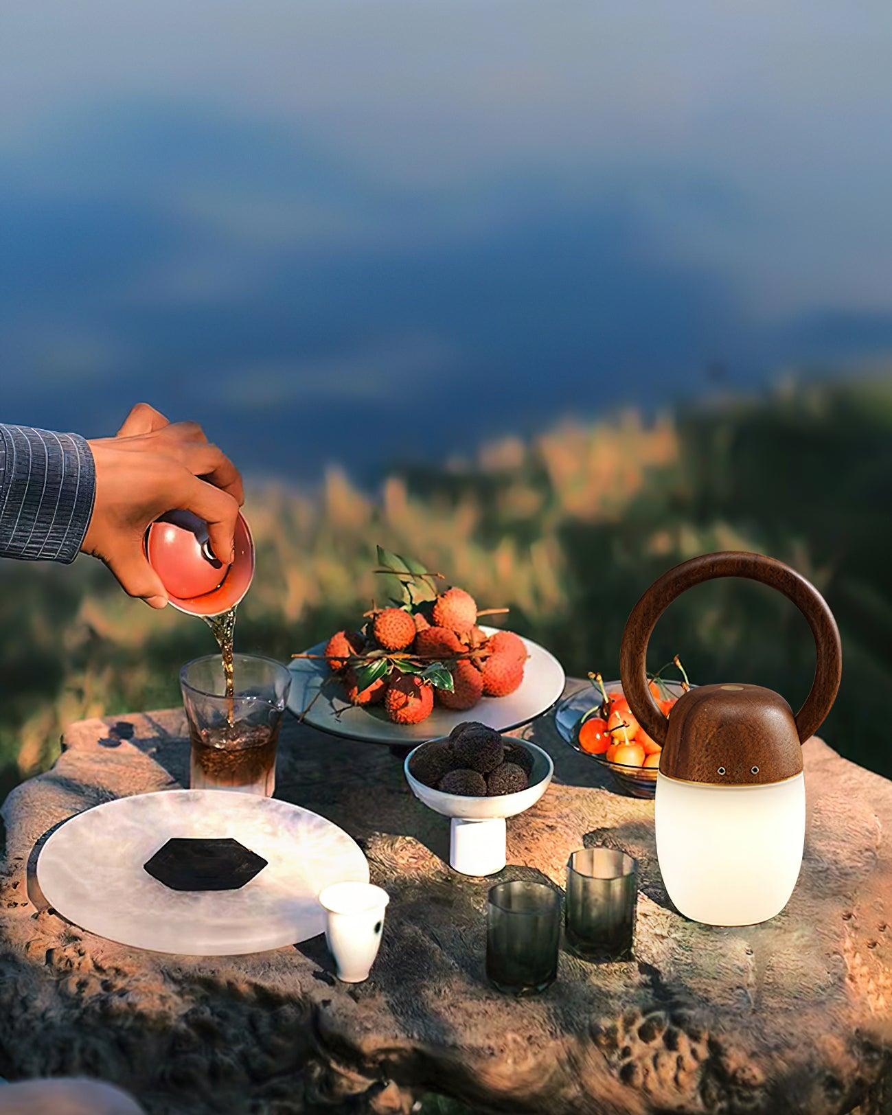 Modern wood and glass table lamp on outdoor table with fruit and drinks, YH Lamps