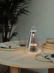 Modern black and clear table lamp with built-in battery on wooden dining table, warm light, YH Lamps