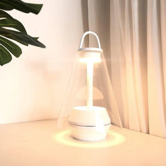 Modern white table lamp with clear shade and warm light on desk, YH Lamps elegant design