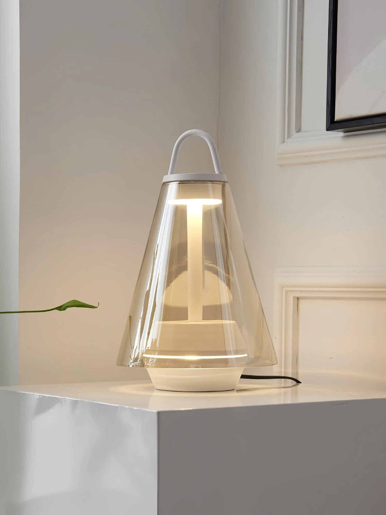 Modern clear glass table lamp with built-in battery and warm light on white surface, YH Lamps